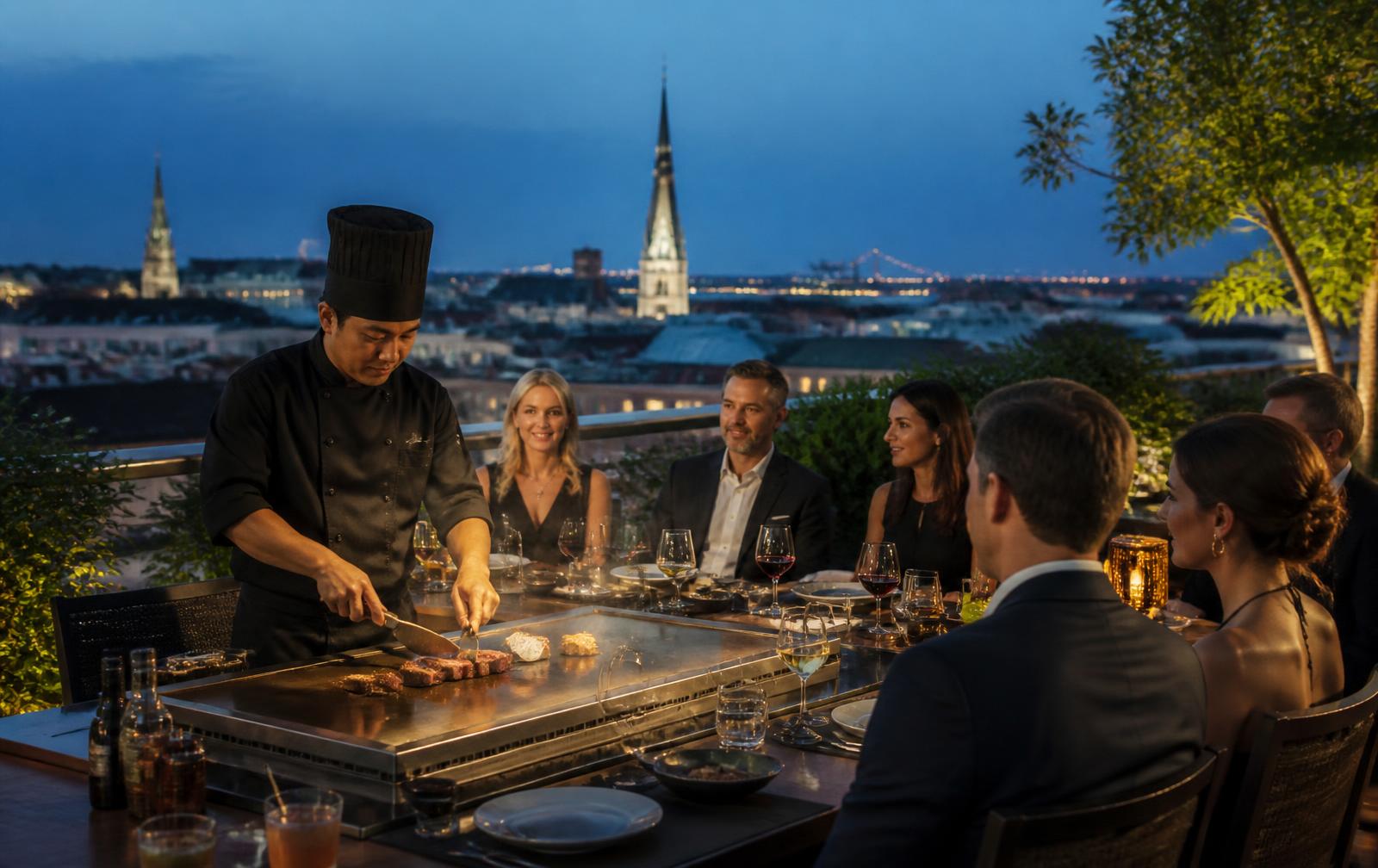 Chef slicing seared steak at a teppanyaki station on a Savannah rooftop at blue hour with church spires behind.